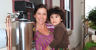 a woman and a baby next to lifesource water tank